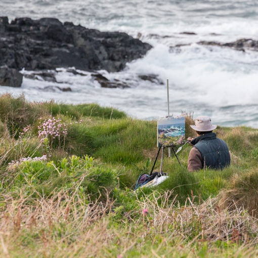 Painter at Clodgy Point, St Ives, Cornwall.